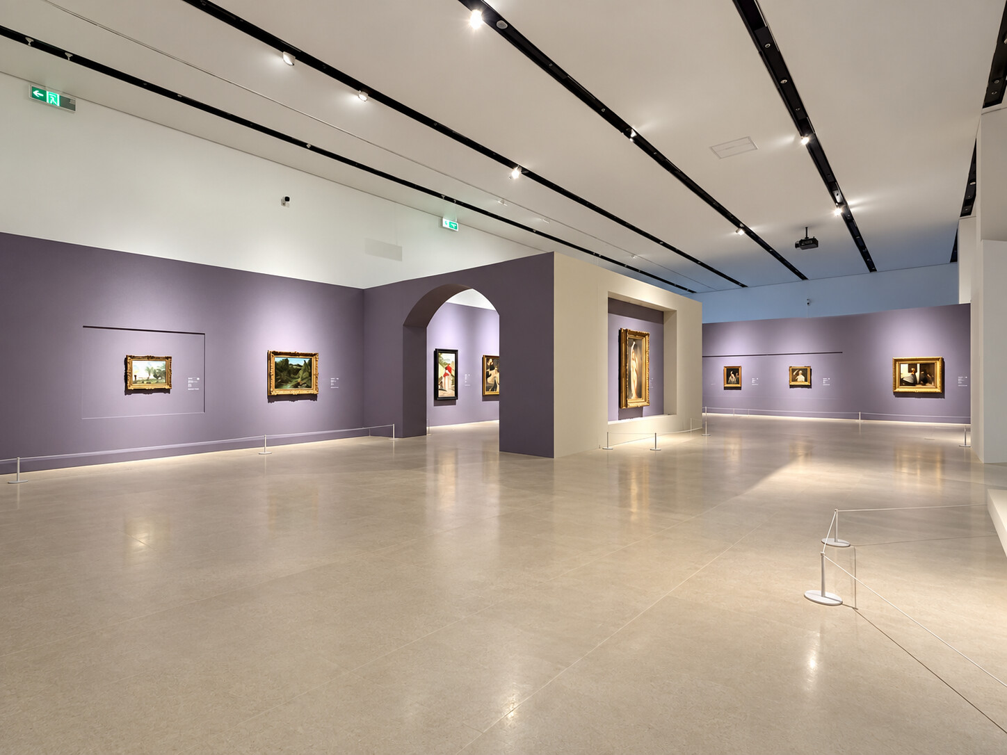 Installation view of The Realm of Masters at Shenzhen International Museum of Art, showing a spacious gallery with lavender walls, framed European paintings, ceiling track lighting, and low rope barriers.
